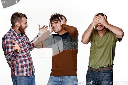 Image of The three men looking with different emotions