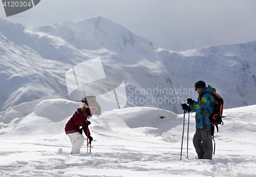 Image of Father and daughter on ski resort after snowfall.