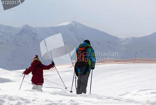 Image of Father and daughter on ski resort after snowfall