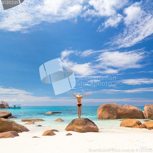 Image of Woman enjoying Anse Lazio picture perfect beach on Praslin Island, Seychelles.