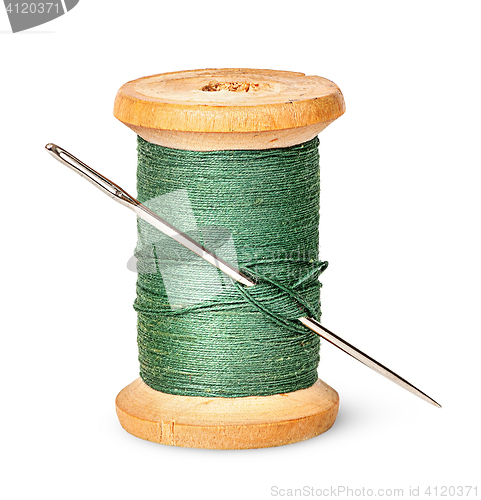 Image of Needle and thread on wooden spool vertically