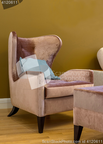 Image of wing chair with blue cushion