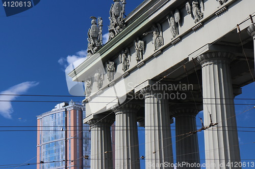 Image of  Triumphal Gate and modern building cityscape