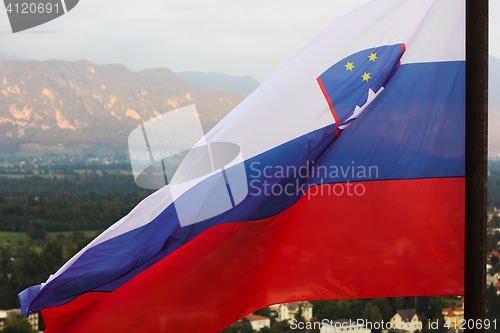 Image of Slovenian national flag fluttering over Lake Bled