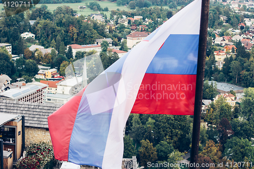 Image of Slovenian national flag fluttering over Lake Bled