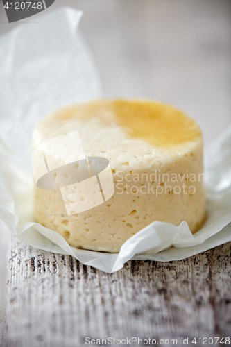 Image of fresh cheese on wooden table