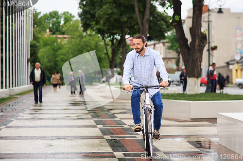 Image of young hipster man with fixed gear bike on city street