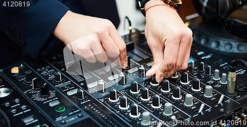 Image of Dj mixes the track in the nightclub at party
