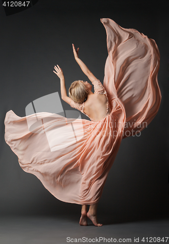 Image of Woman dancing in light dress