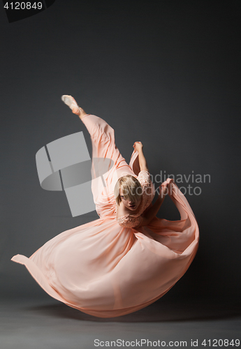 Image of Woman dancing in light dress