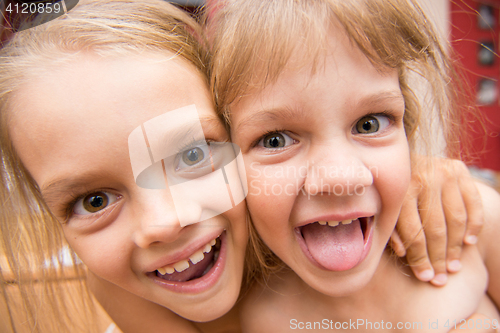 Image of Close-up portrait of two girls five and seven years