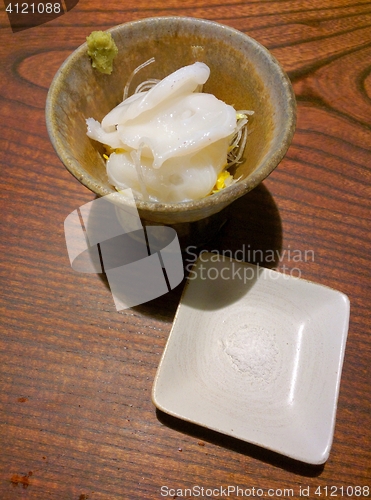 Image of Slices of japanese octopus in a bowl with salt