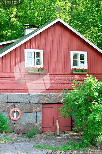 Image of Wooden red coastal house in Finland