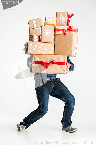 Image of Gift boxes in the hands of young man
