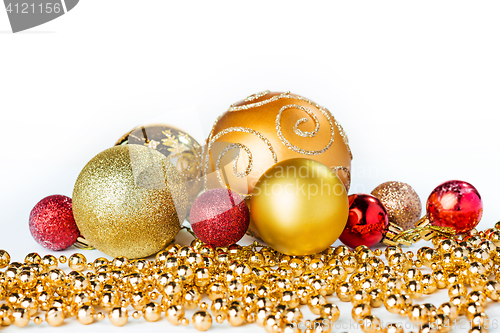 Image of Gold Christmas balls on white