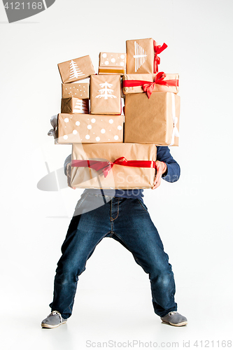 Image of Gift boxes in the hands of young man