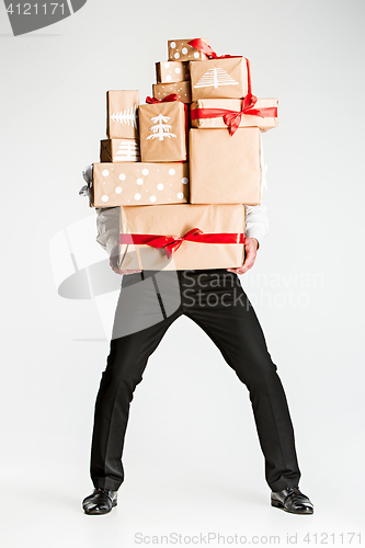 Image of Gift boxes in the hands of young man