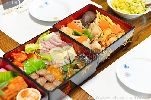 Image of Osechi, traditional Japanese New Year food, in black lacqueware boxes
