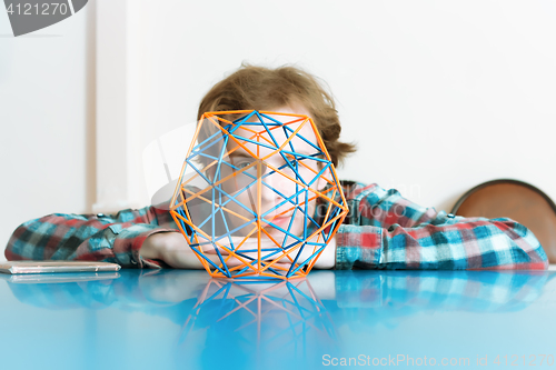 Image of Young Man And The Volumetric Model Of Geometric Solid