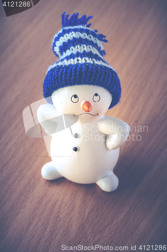 Image of Cute Snowman on Wooden Table