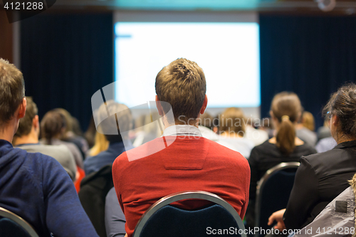 Image of Audience in lecture hall participating at business conference.