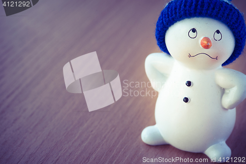 Image of Cute Snowman on Wooden Table