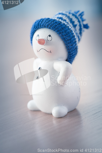 Image of Cute Snowman on Wooden Table