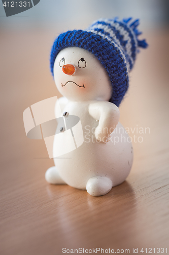 Image of Cute Snowman on Wooden Table