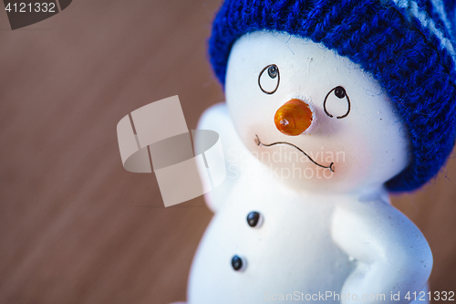 Image of Cute Snowman on Wooden Table