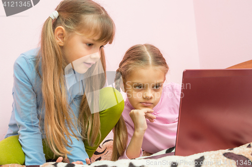 Image of Sisters looking at a laptop cartoon