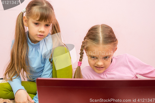 Image of Girls look at the screen a bit tired of the view