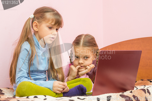 Image of The sisters are interested in watching a laptop screen