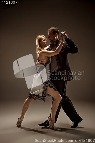 Image of The man and the woman dancing argentinian tango