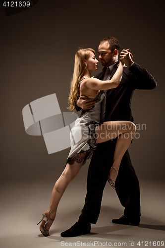 Image of The man and the woman dancing argentinian tango