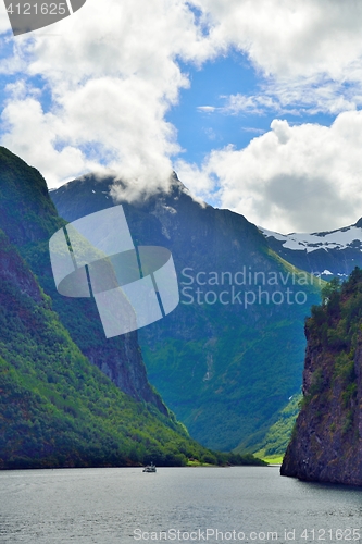 Image of Naeroyfjord and a small ferry