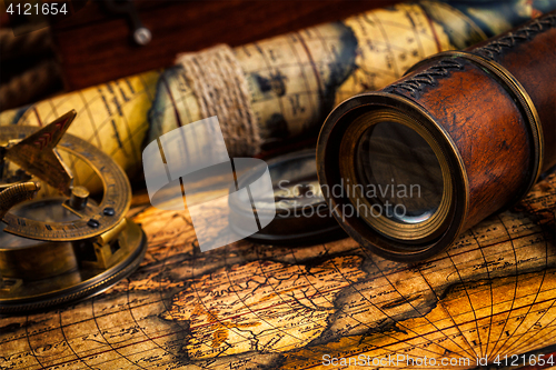 Image of Old vintage compass and navigation instruments on ancient map