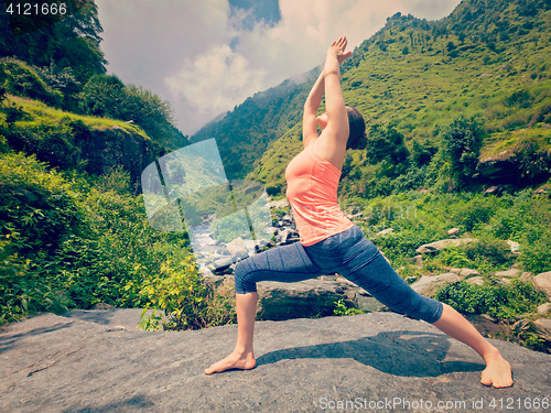 Image of Woman doing Ashtanga Vinyasa Yoga asana Virabhadrasana 1 Warrior