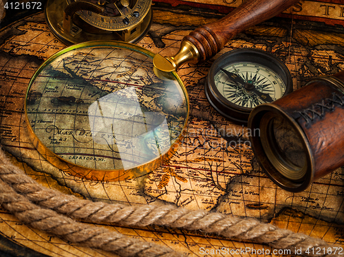 Image of Old vintage compass and navigation instruments on ancient map