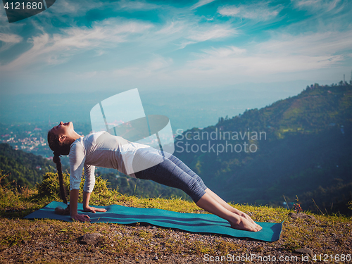 Image of Woman doing Hatha yoga asana Purvottanasana