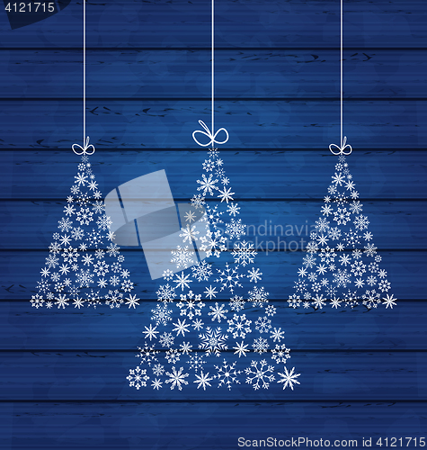 Image of Holiday wooden background with Christmas pines made of snowflake