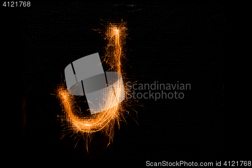 Image of Letter J made of sparklers on black