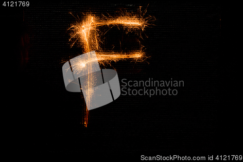 Image of Letter F made of sparklers on black