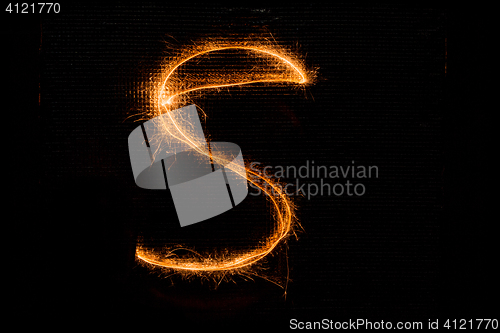 Image of Letter S made of sparklers on black