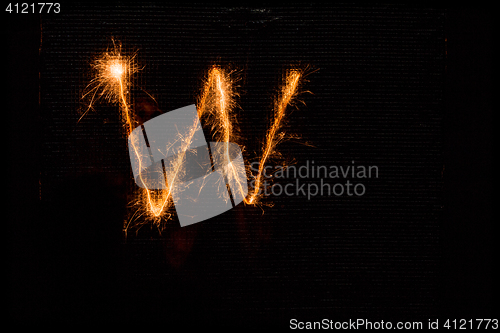 Image of Letter W made of sparklers on black