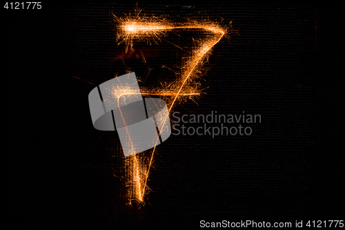 Image of Number 7 made of sparklers on black