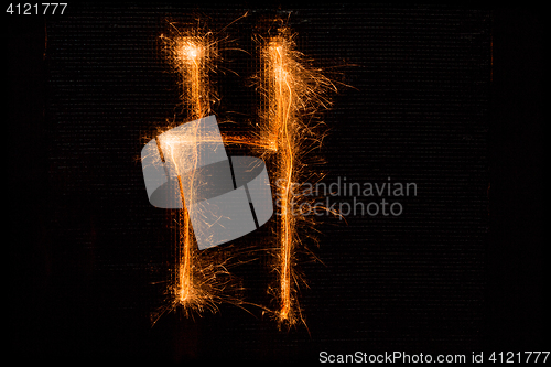 Image of Letter H made of sparklers on black