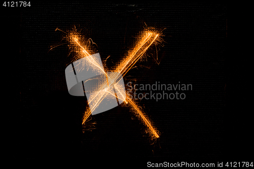 Image of Letter X made of sparklers on black
