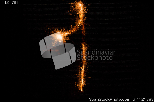 Image of Number 1 made of sparklers on black