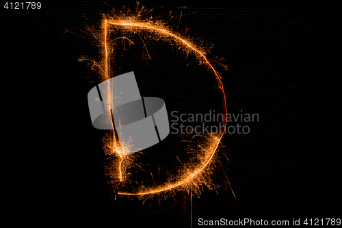 Image of Letter D made of sparklers on black