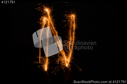 Image of Letter N made of sparklers on black